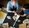Professor discussing fossils with a student.