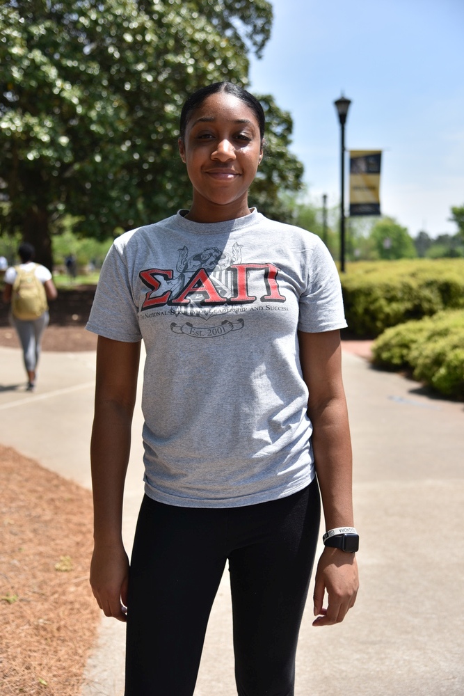 NSLS Member Wearing a Sigma Alpha Pi Shirt.